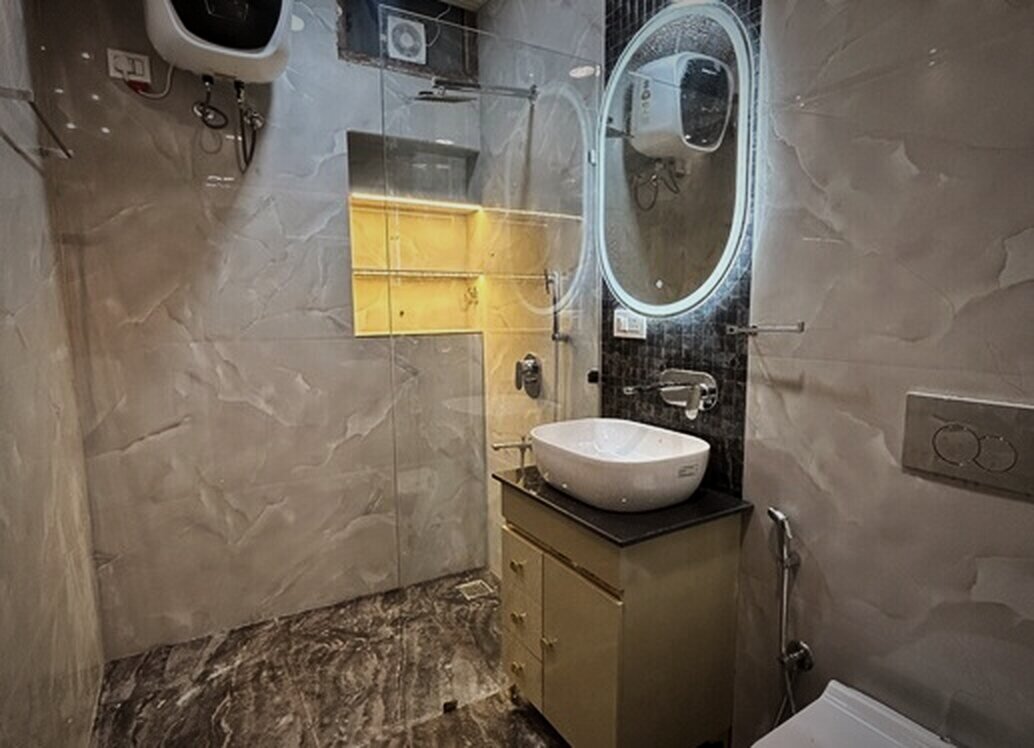 Bathroom in grey marble with a backlit mirror