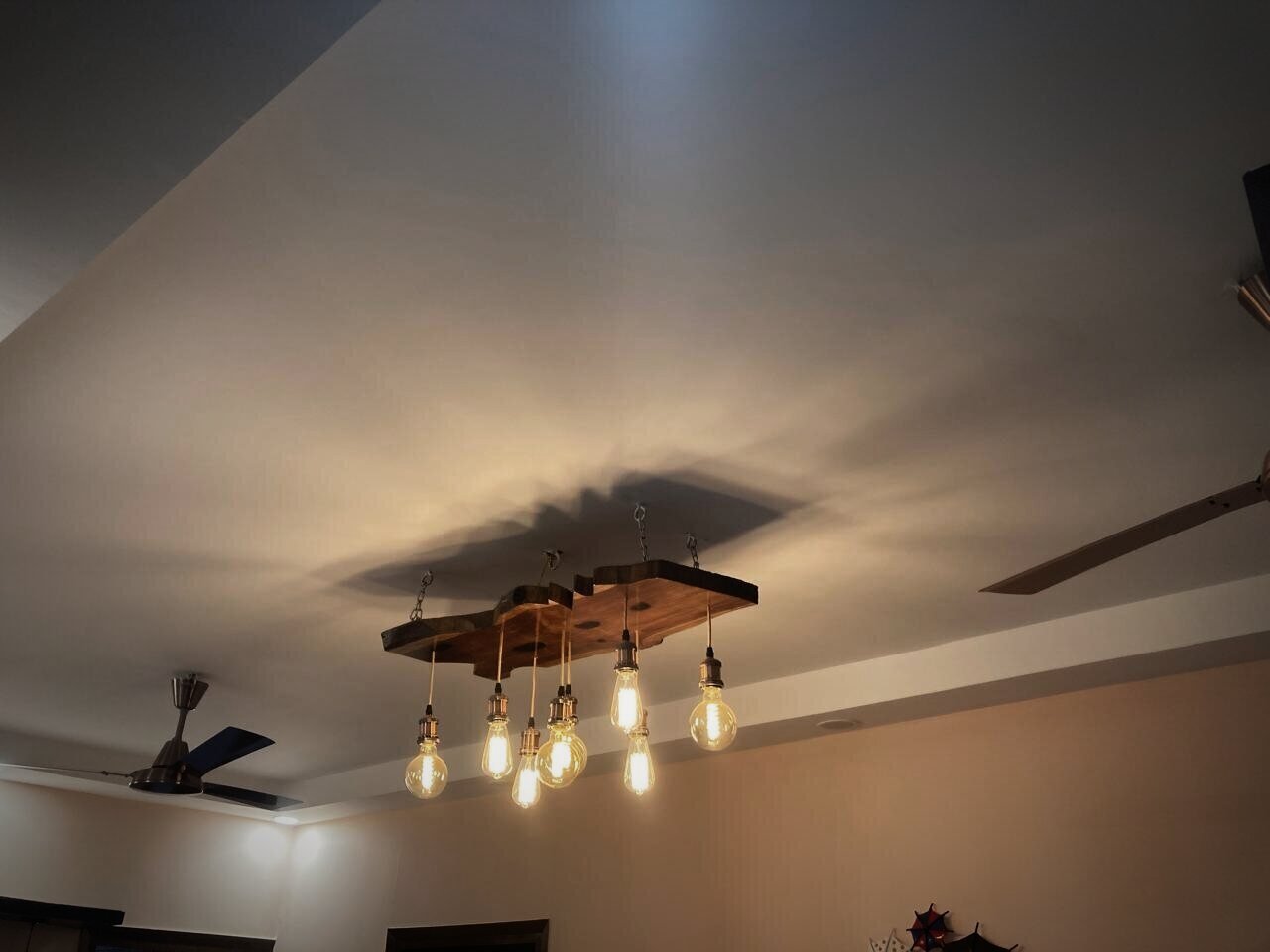 Live-edge timber chandelier with filament bulbs
