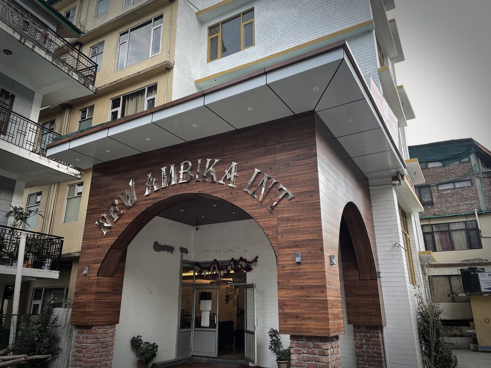 Arched entrance portal clad in wood-finish panels