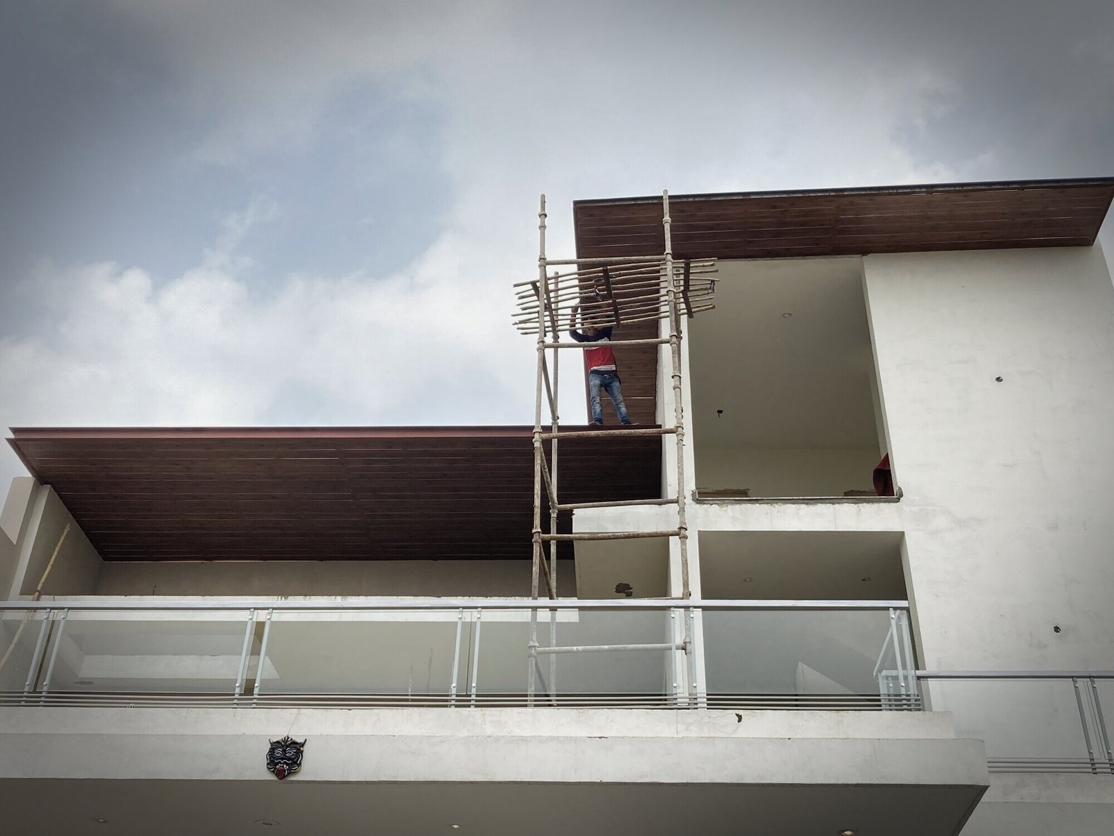 White house with a wood-finish soffit during finishing