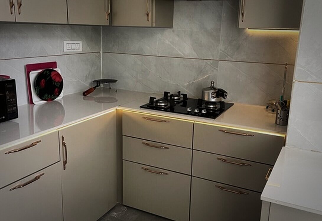Beige modular kitchen with cove lighting