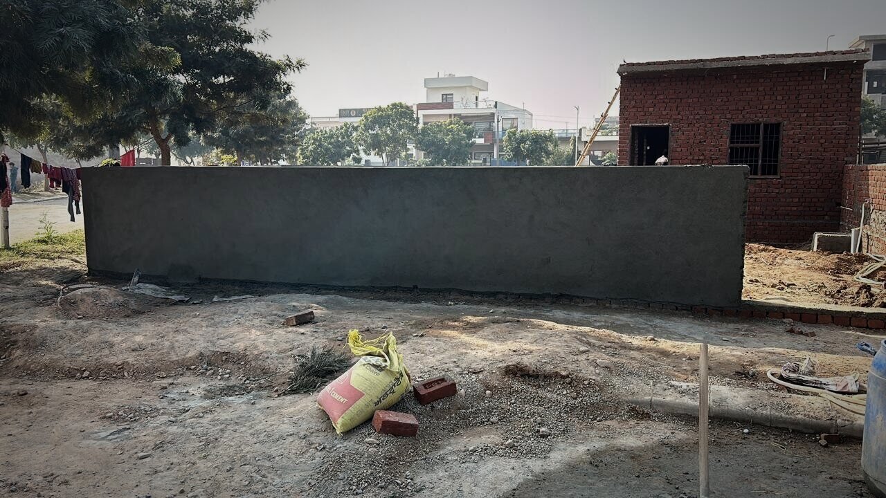 Plastered boundary wall on a residential plot
